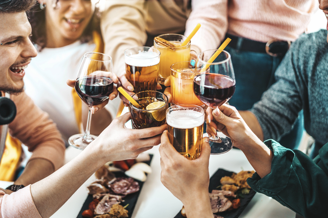 Multiracial friends celebrating party drinking cocktails at bar restaurant - Young people having fun hanging out on weekend day - Life style concept with guys and girls enjoying time together